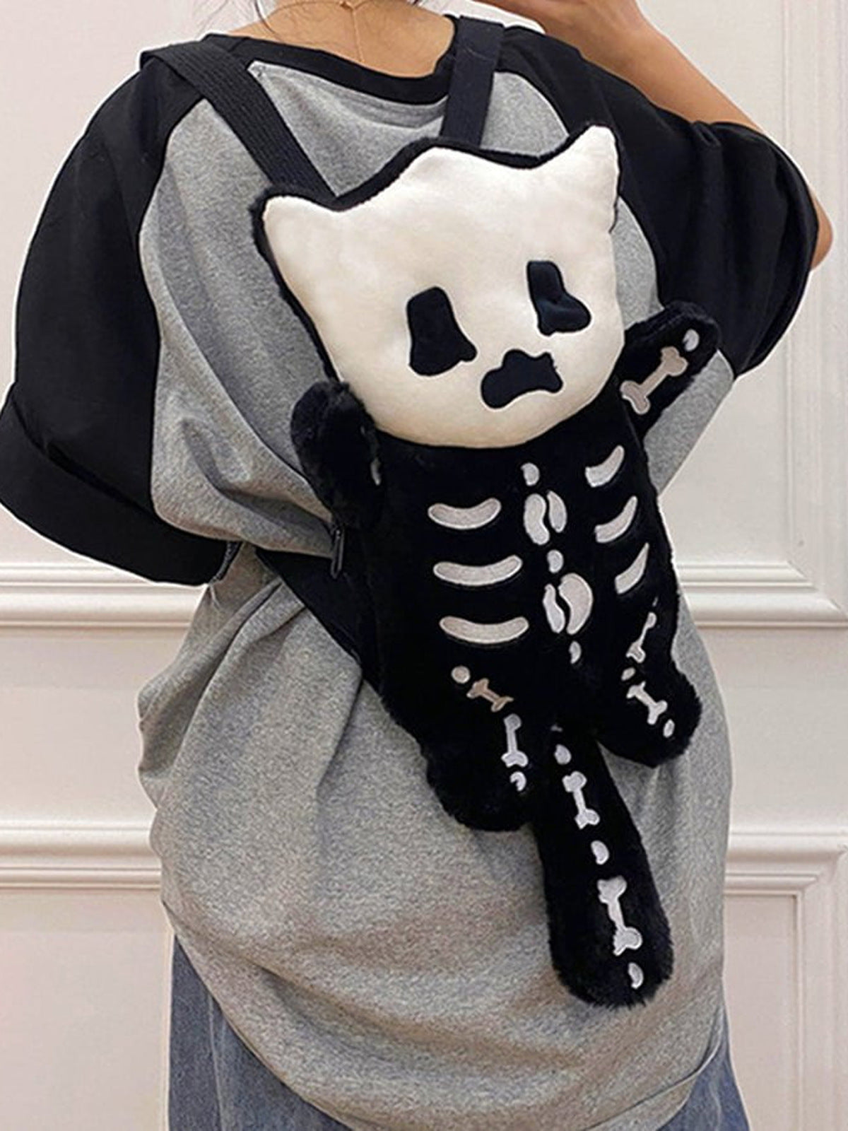 Plush Skeleton Cat Backpack with Tail – on model, back view | XoKool