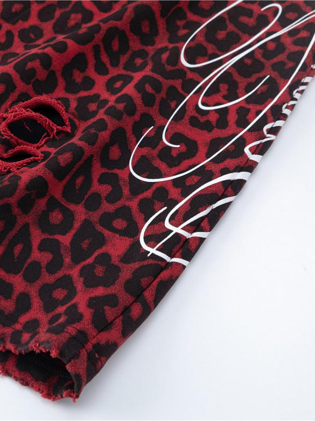 Leopard sweatpants – Distressed hole and script print close-up | XoKool