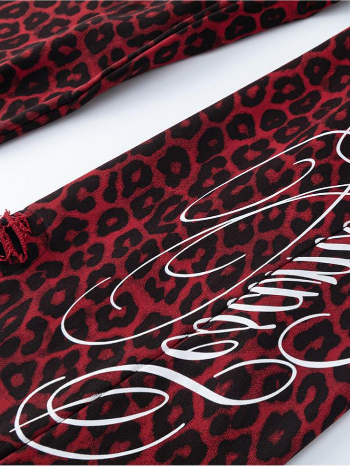 Leopard sweatpants – Script print and frayed hem close-up | XoKool
