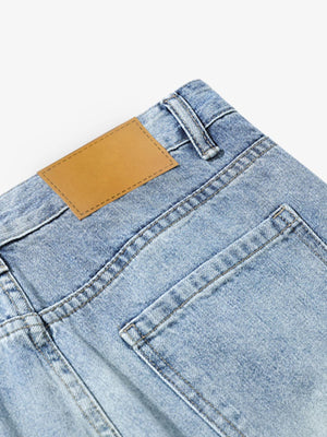 Ripped Flare Jeans – Back pocket + leather patch close-up | XoKool