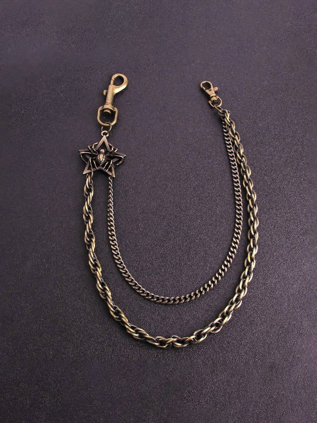 Spider Emblem Wallet Chain in Antique Brass – Brass, flat on purple | XoKool