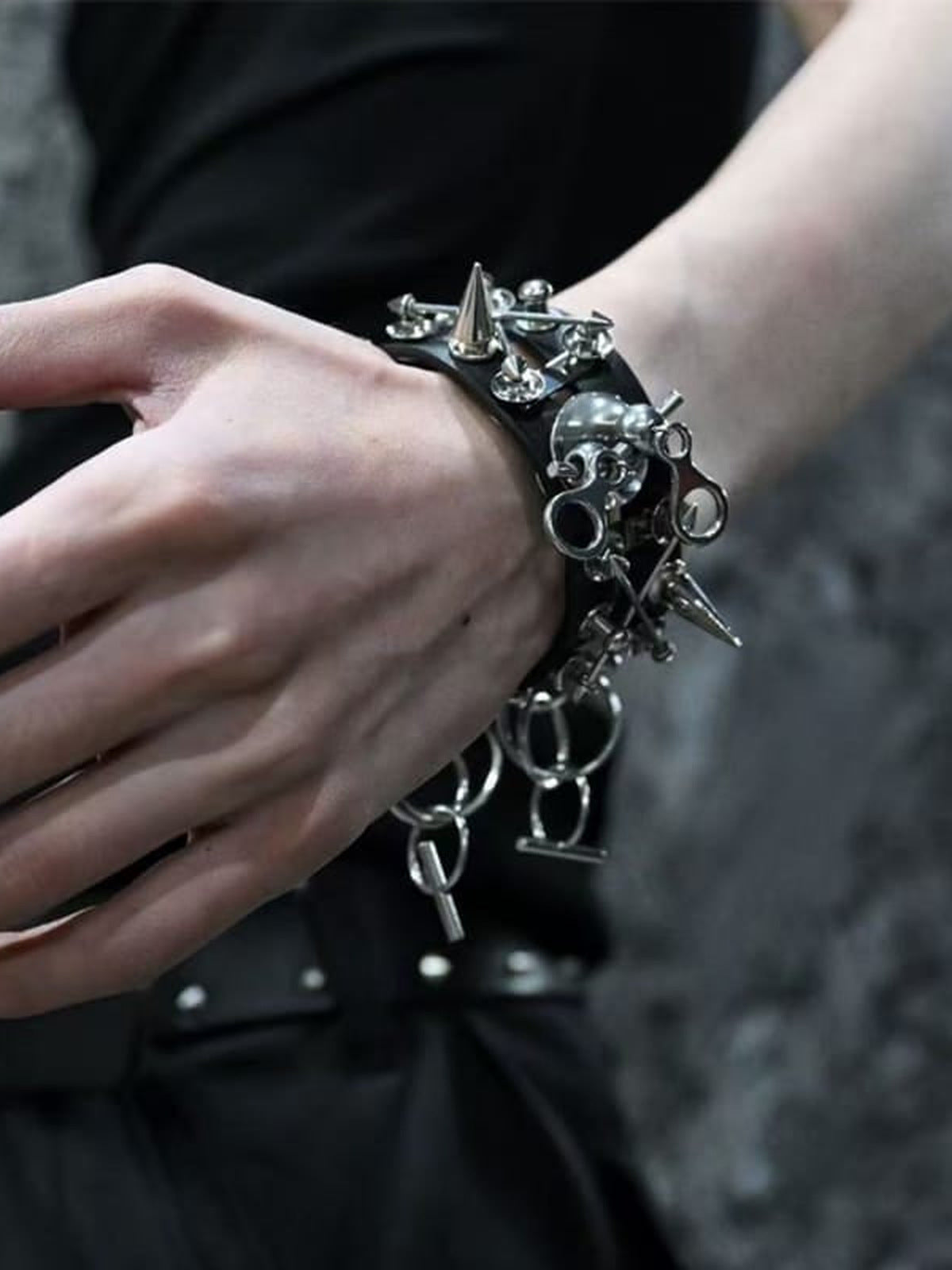 Armband aus Kunstleder mit Nieten und Totenkopf-Anhänger – am Handgelenk, Vorderansicht | XoKool