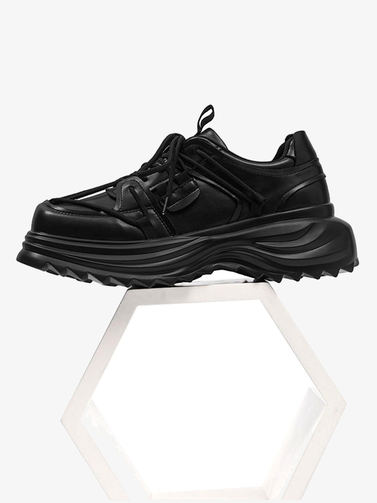 All black sneakers – side on plinth | XoKool