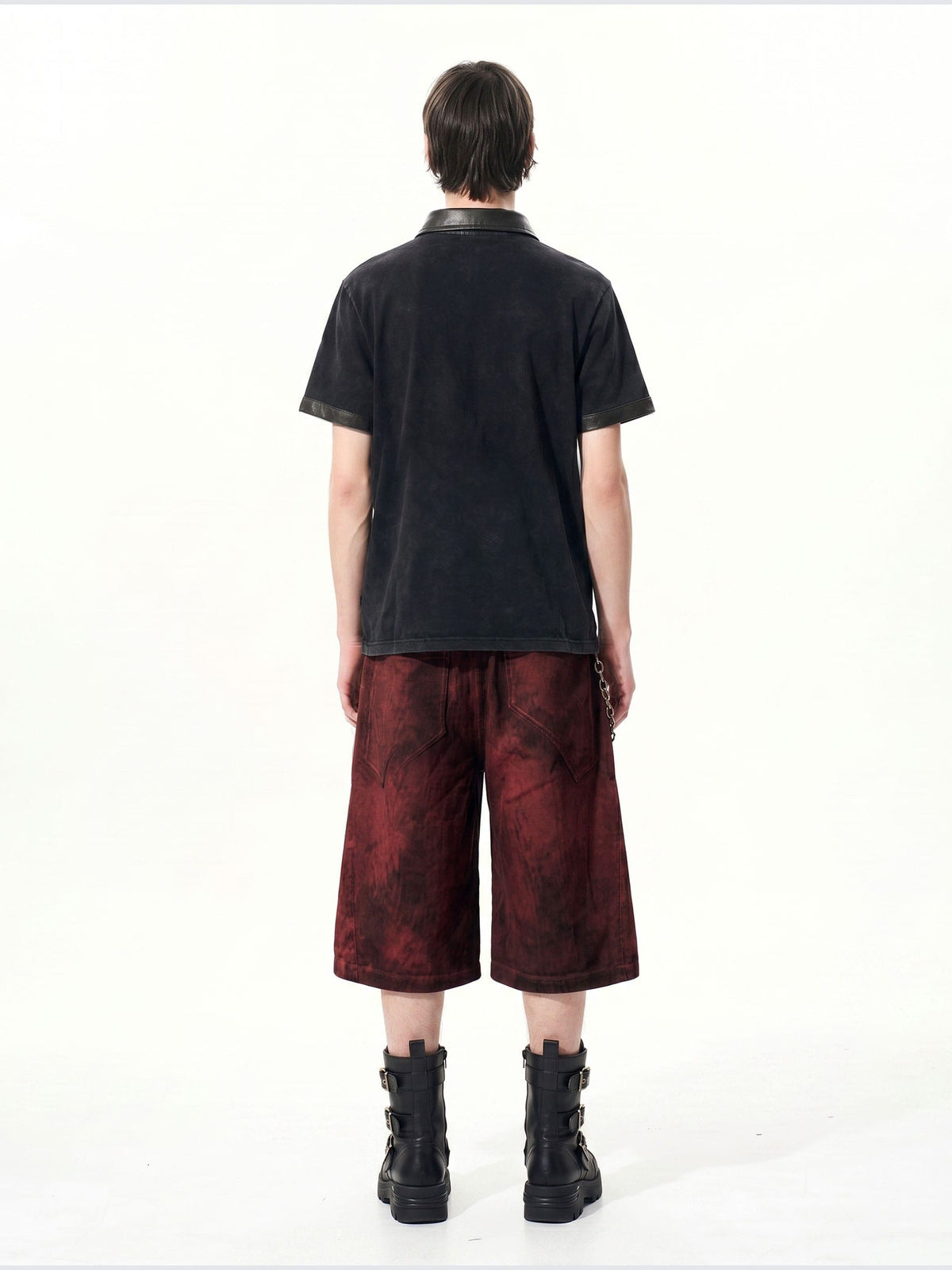 Washed black polo shirt – on model, back | XoKool