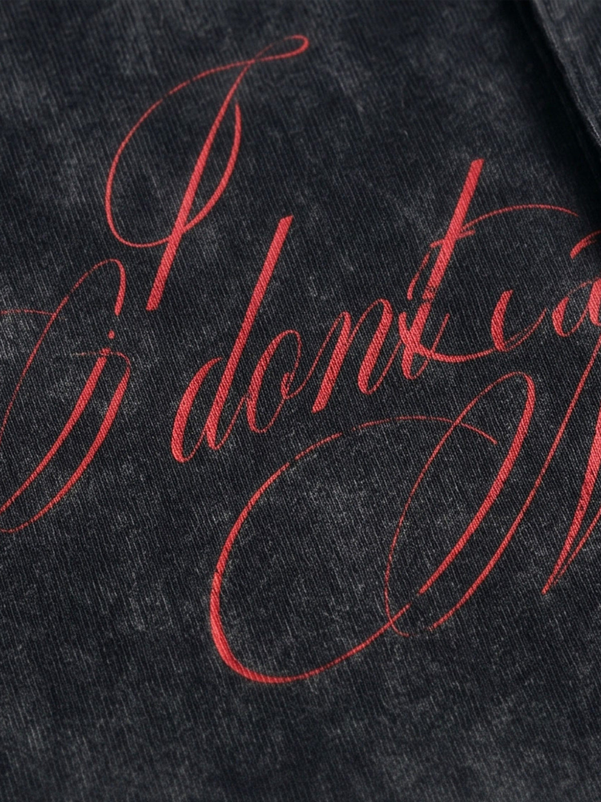 Washed black polo shirt – script print close-up | XoKool