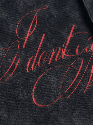 Washed black polo shirt – script print close-up | XoKool